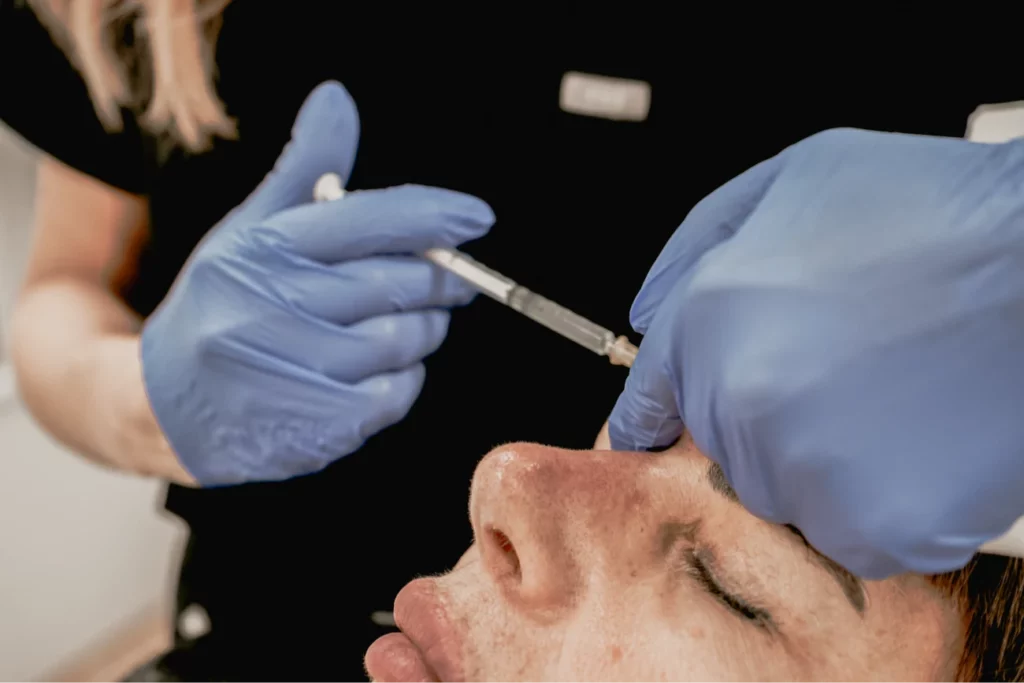 Facial aesthetics doctor consulting patient at Chelsea clinic